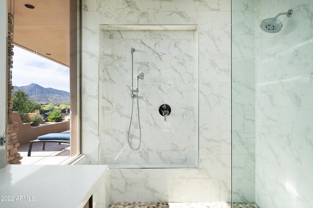 bathroom featuring a mountain view and tiled shower