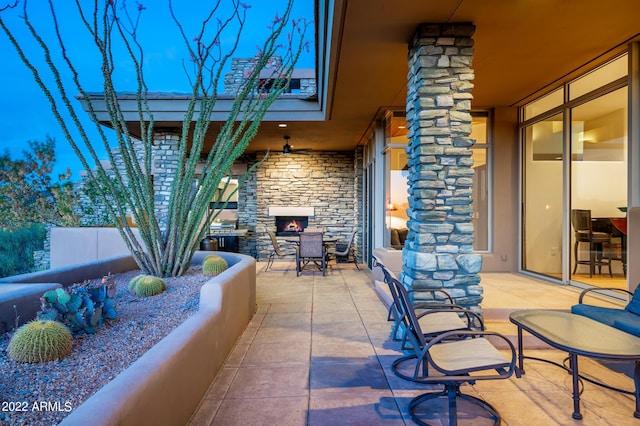 view of patio with an outdoor stone fireplace