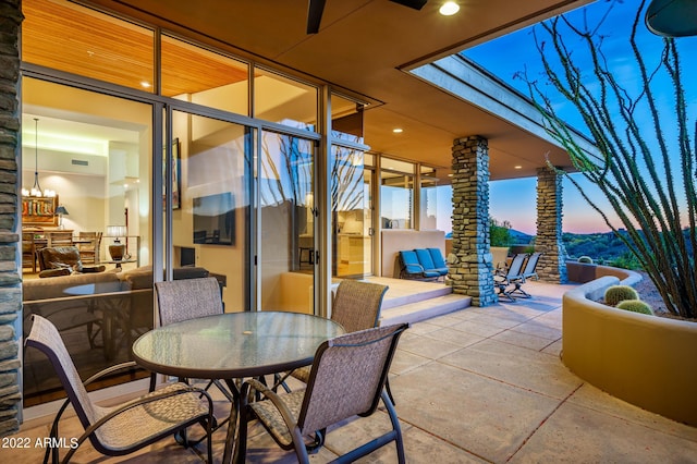 view of patio terrace at dusk