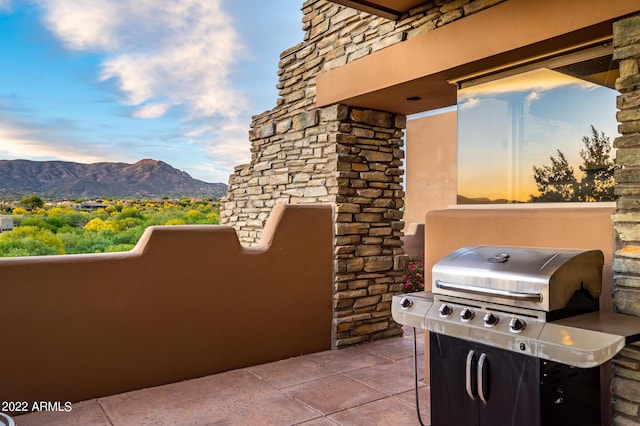 patio terrace at dusk with a grill and a mountain view