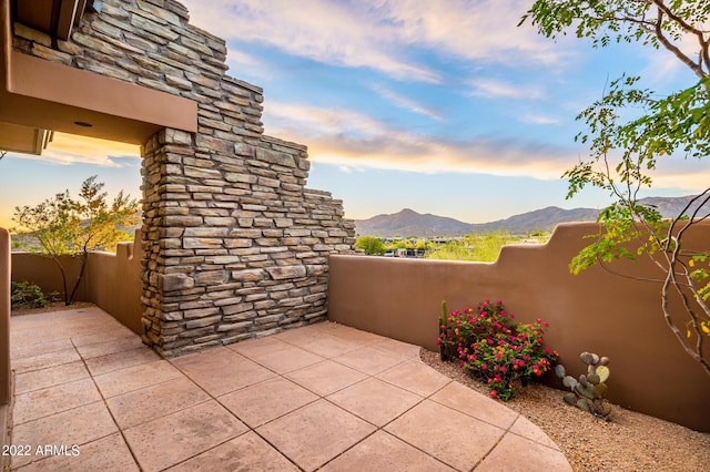 patio terrace at dusk with a mountain view