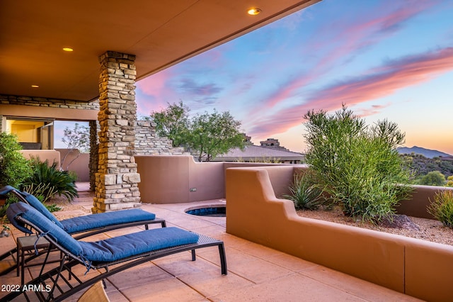 view of patio terrace at dusk