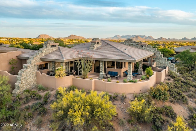 back of property featuring a patio and a mountain view