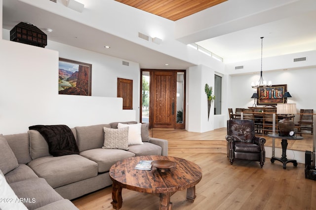 living room featuring a notable chandelier and light hardwood / wood-style floors