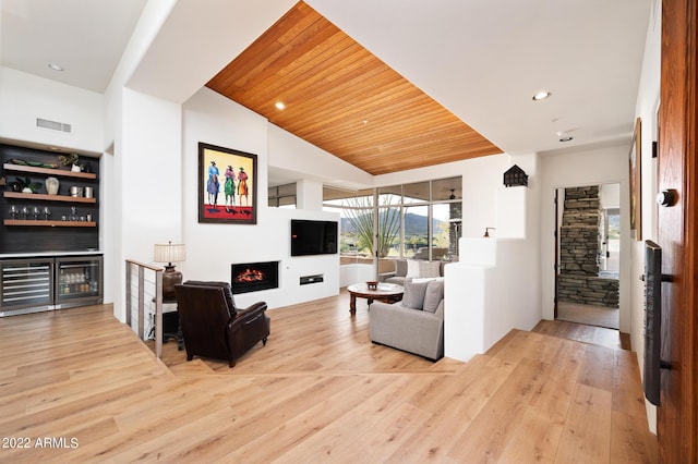 living room featuring vaulted ceiling, wooden ceiling, wine cooler, and light wood-type flooring