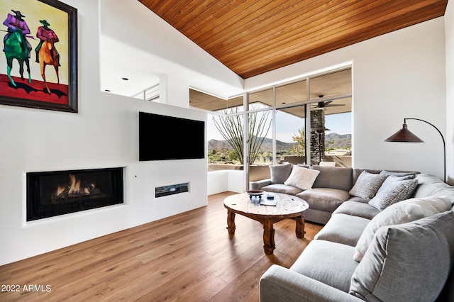 living room with high vaulted ceiling, hardwood / wood-style floors, and wooden ceiling