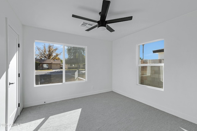 unfurnished room with ceiling fan and light carpet