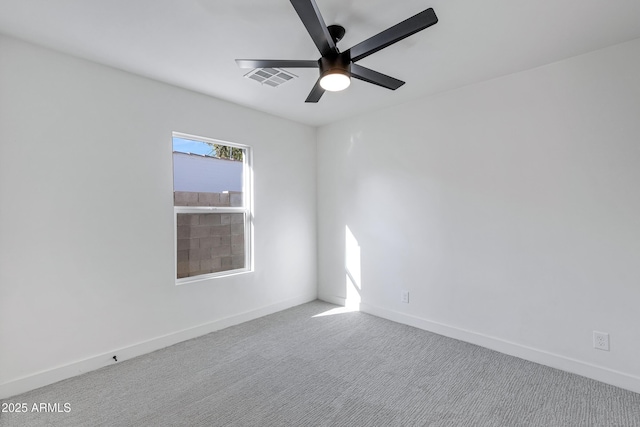 spare room with ceiling fan and light colored carpet