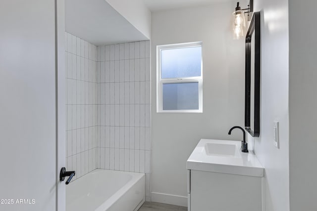 bathroom featuring vanity and tiled shower / bath