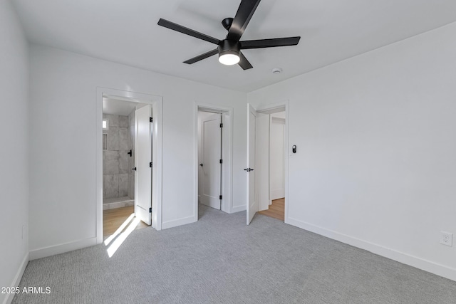 unfurnished bedroom with light carpet, ensuite bathroom, and ceiling fan