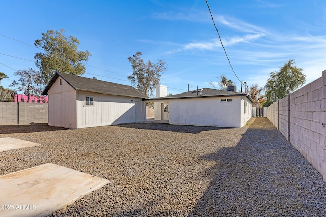 back of house with an outdoor structure