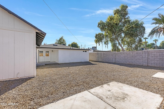 view of yard featuring french doors and a patio