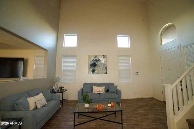 19886 W Woodlands Ave, Buckeye, AZ 85326 - living area featuring a towering ceiling, stairs, wood finished floors, and healthy amount of natural light