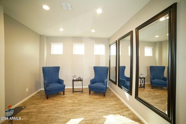 19886 W Woodlands Ave, Buckeye, AZ 85326 - living area featuring light wood-style floors, recessed lighting, and baseboards