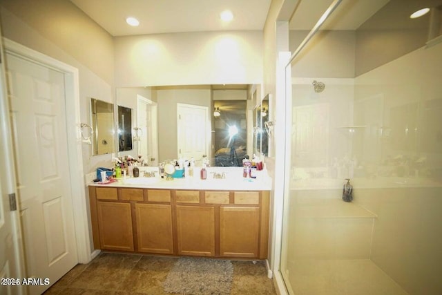 19886 W Woodlands Ave, Buckeye, AZ 85326 - bathroom with a walk in shower, double vanity, and recessed lighting
