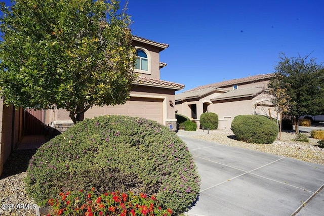 19886 W Woodlands Ave, Buckeye, AZ 85326 - view of front of property featuring stucco siding, a tiled roof, and an attached garage