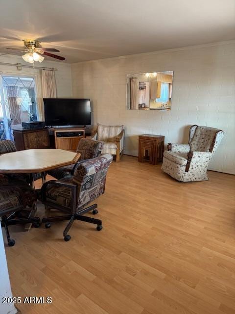 office with light hardwood / wood-style floors and ceiling fan