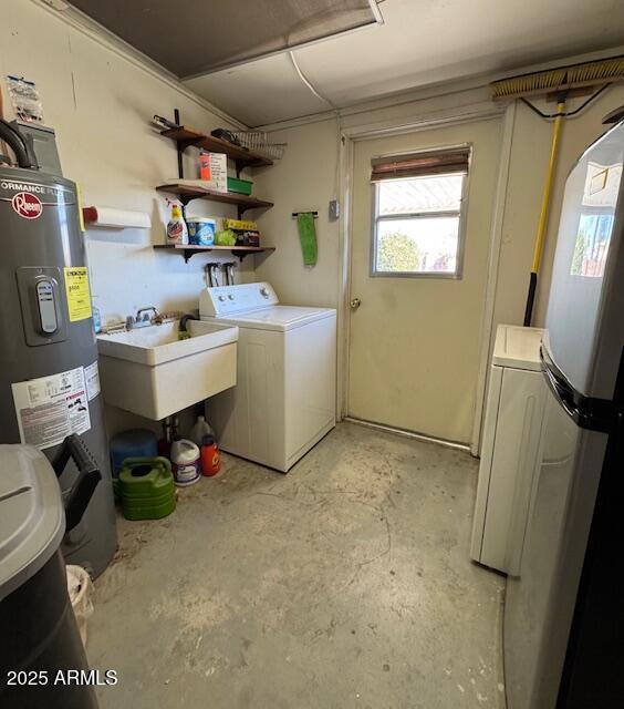 laundry area with independent washer and dryer, electric water heater, and sink