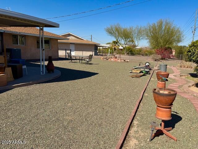 view of yard featuring a patio and central air condition unit