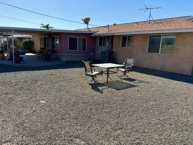 rear view of property featuring central AC and a patio