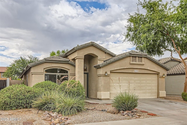 12333 W Marshall Ave, Litchfield Park, AZ 85340 - mediterranean / spanish-style home featuring a tile roof, driveway, a garage, and stucco siding