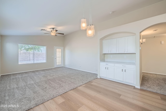 12333 W Marshall Ave, Litchfield Park, AZ 85340 - unfurnished room featuring baseboards, arched walkways, a ceiling fan, light wood finished floors, and lofted ceiling