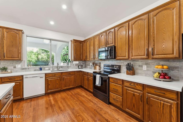3750 E Palm St, Mesa, AZ 85215 - kitchen featuring white dishwasher, stainless steel microwave, black electric range oven, a sink, and backsplash