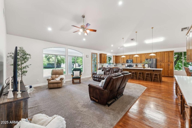 3750 E Palm St, Mesa, AZ 85215 - living area with vaulted ceiling, ceiling fan, healthy amount of natural light, wood finished floors, and recessed lighting