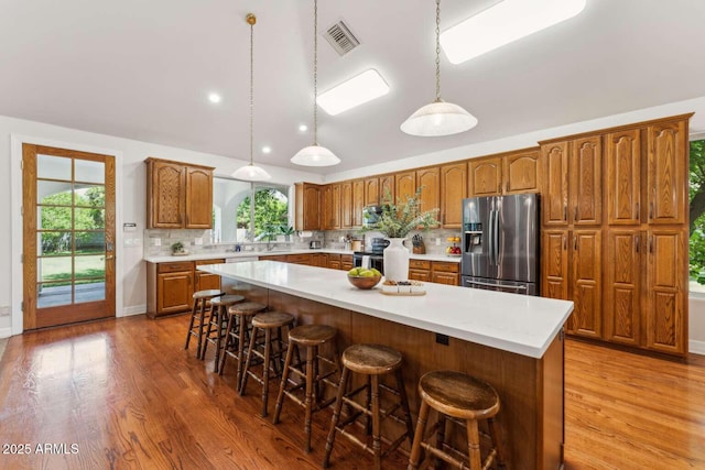 3750 E Palm St, Mesa, AZ 85215 - kitchen with stainless steel appliances, light countertops, tasteful backsplash, wood finished floors, and lofted ceiling