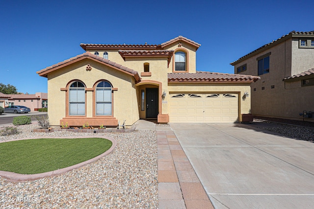 mediterranean / spanish-style home featuring a garage