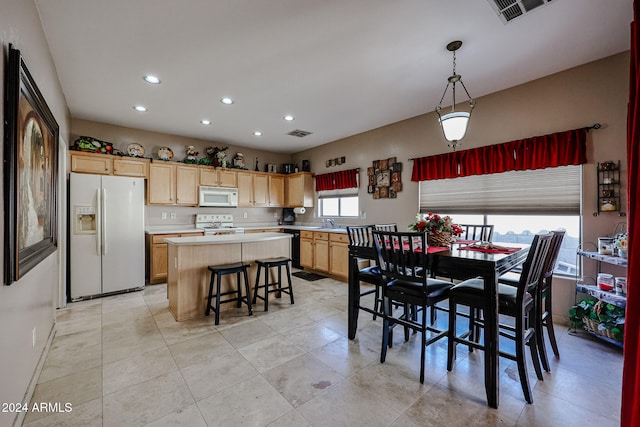 tiled dining room featuring sink