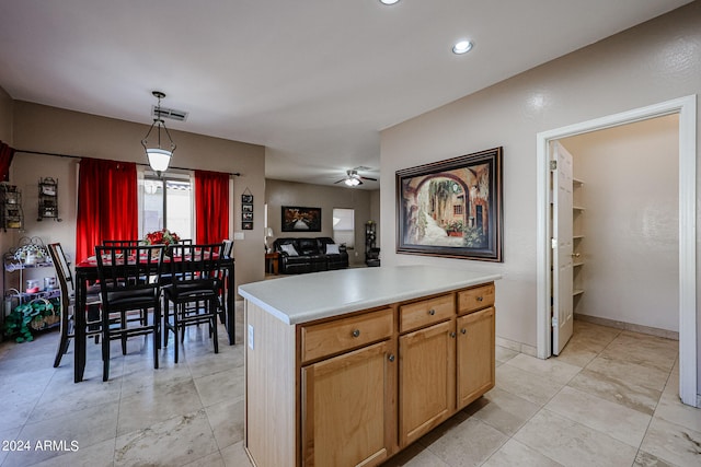 kitchen featuring a kitchen island, hanging light fixtures, and ceiling fan