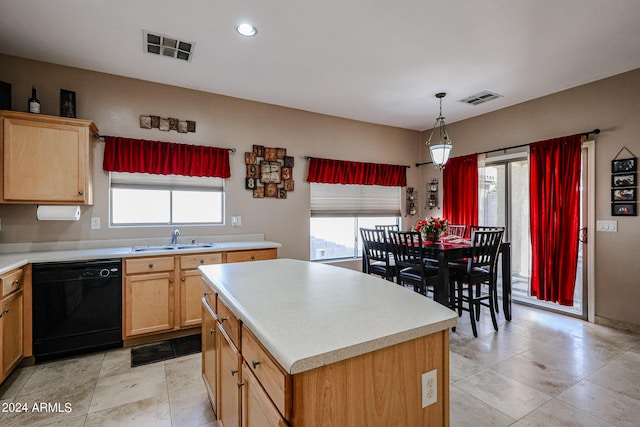 kitchen featuring black dishwasher, sink, decorative light fixtures, and a kitchen island