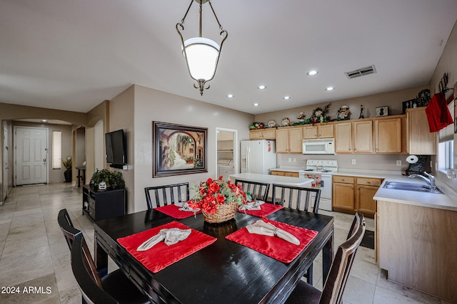 tiled dining space featuring sink