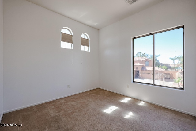 empty room with carpet floors and plenty of natural light