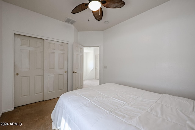 bedroom with a closet, ceiling fan, and light colored carpet