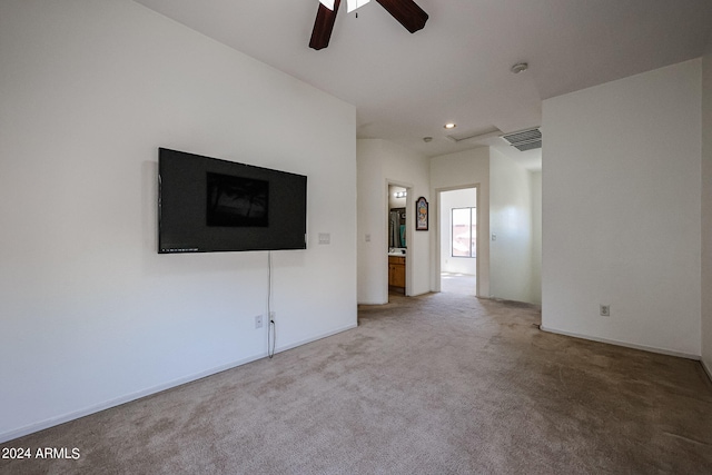 unfurnished living room featuring ceiling fan and carpet flooring