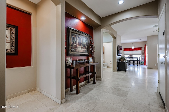 hall with light tile patterned floors