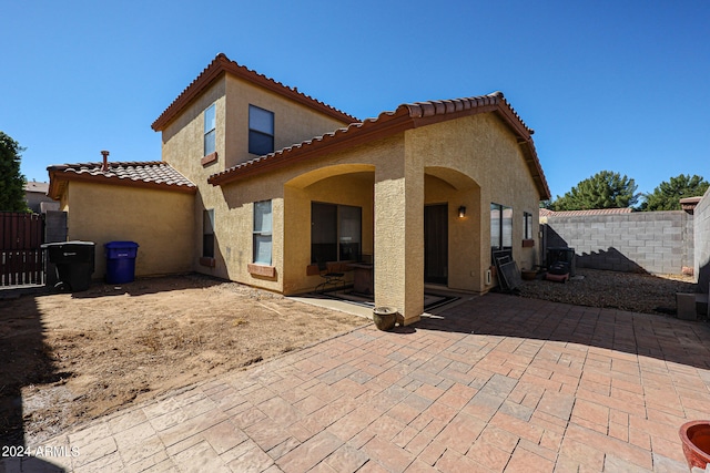 back of property with a patio