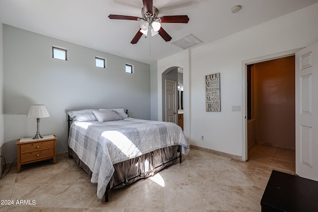 bedroom with ceiling fan and ensuite bathroom