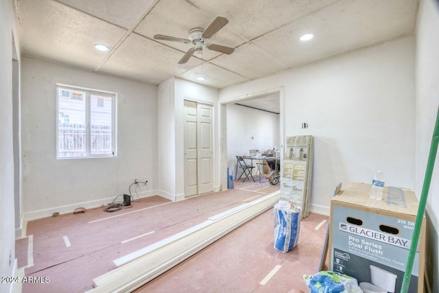 bathroom featuring ceiling fan and a drop ceiling