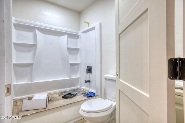 bathroom with a shower and toilet