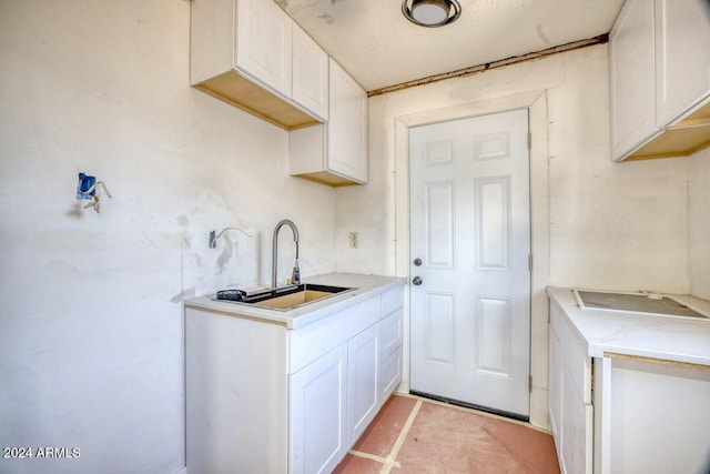 kitchen featuring white cabinetry and sink