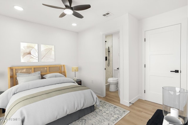 bedroom with connected bathroom, light hardwood / wood-style flooring, and ceiling fan