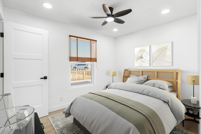 bedroom with ceiling fan and light hardwood / wood-style floors