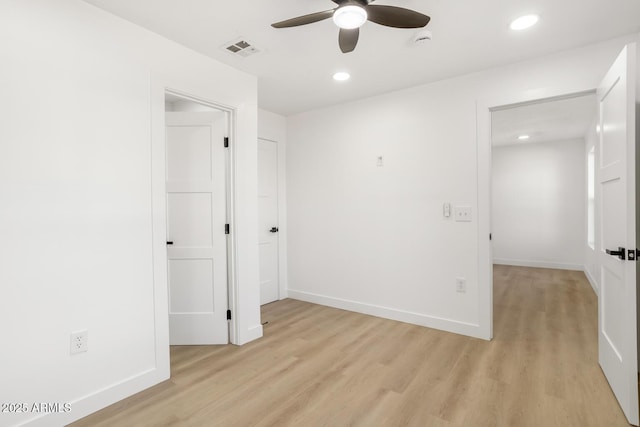 empty room featuring light wood-type flooring and ceiling fan