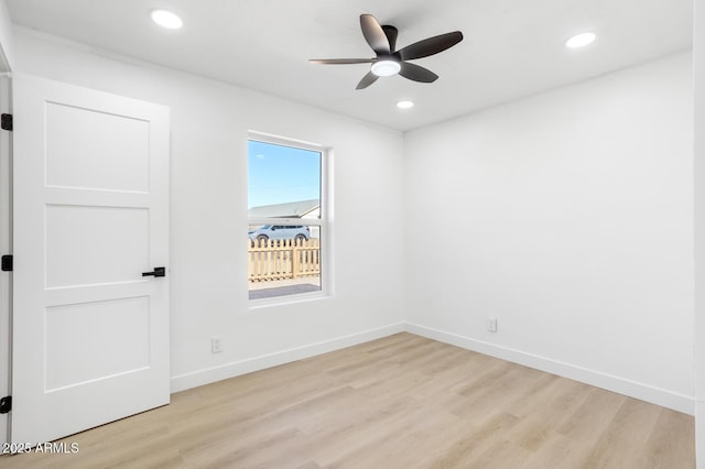 spare room with ceiling fan and light wood-type flooring