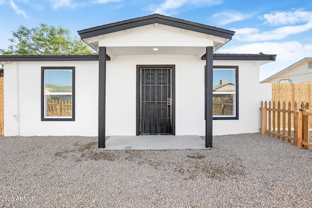 property entrance featuring a patio area