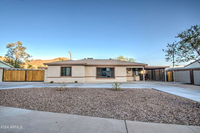 ranch-style house featuring a mountain view and a carport