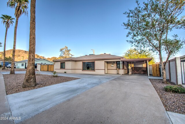 single story home featuring a mountain view and a carport